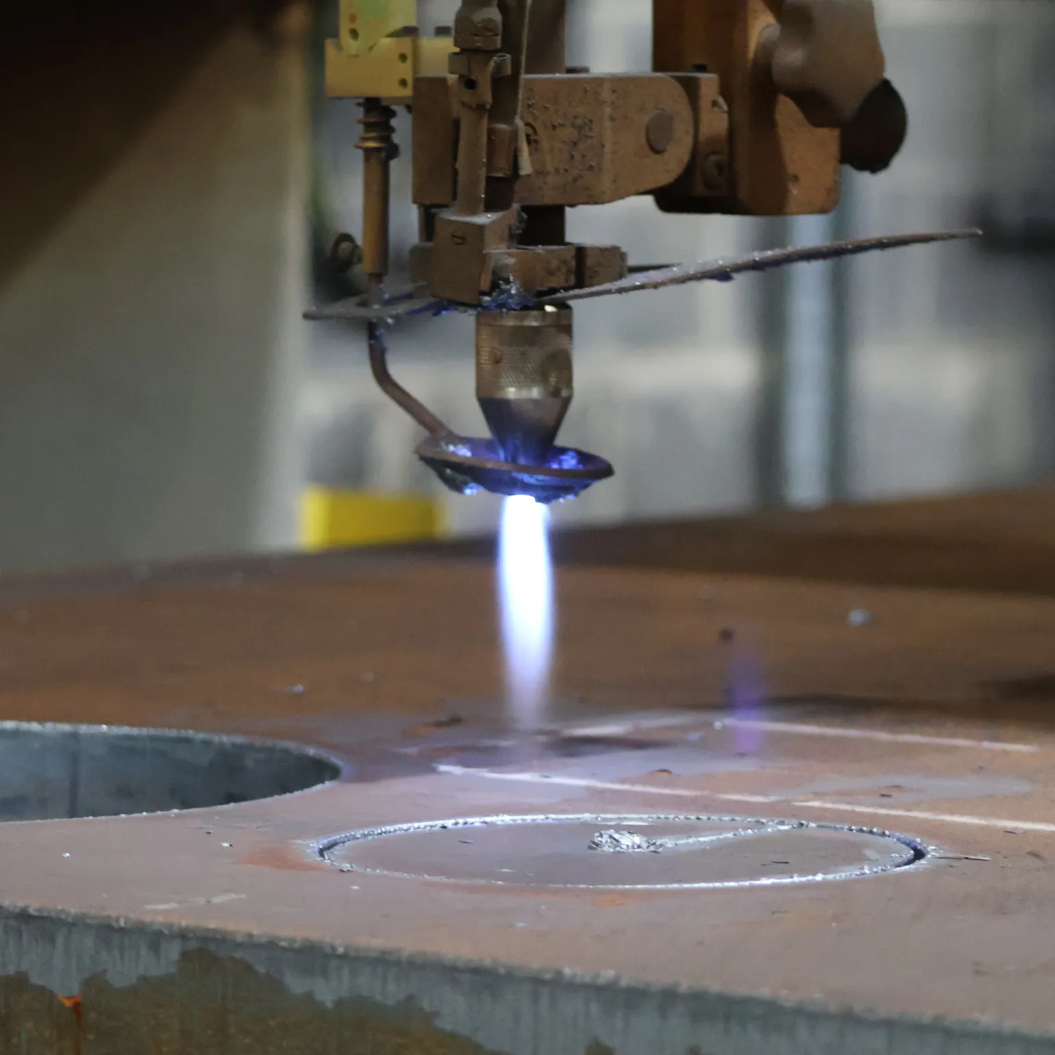 What is gas cutting?

Gas cutting or oxy-fuel cutting is a metal cutting technique that uses heat generated by the combustion of fuel gases like acetylene combined with pure oxygen. A specialised cutting torch combines these gases and creates a flame that can cleanly cut metal, first by heating it to a kindling temperature and then oxidising it with a stream of pure oxygen to melt the metal along its cutting line.

This type of metal cutting is ideal for use on thicker metals like low-alloy steel and mild steel. It is used for a range of applications, including scrap metal processing, metal fabrication, demolition, and salvage, and creating bevelled edges. It is also a generally cost-effective method.
